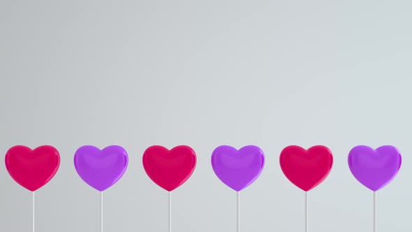 Red purple hearts on white sticks on blue isolated background