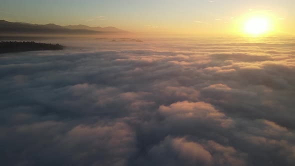 Aerial of the sunrise above the clouds