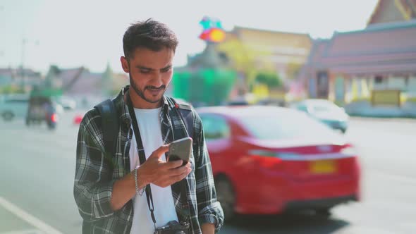 Young lost Asian tourist searching for information on his phone, Lost in the city. 