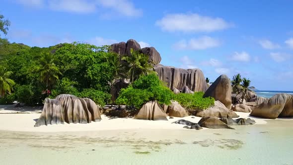 Aerial drone shot of the tropical anse source d'argent in the beautiful Seychelles.