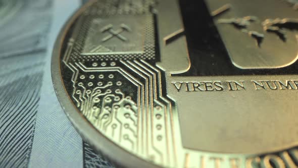 Gold Popular Crypto Coin Litecoin in Macro Shot with American Dollar Bank Note on the Table. Digatal