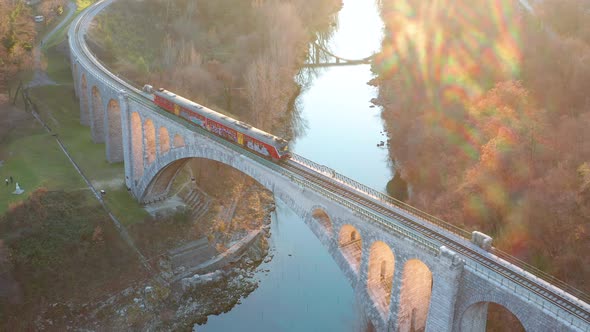 Aerial - Train crossing stone arch railrode bridge, Solkan Slovenia