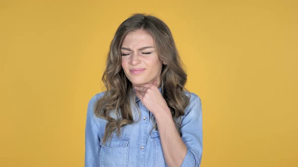 Sick Young Girl Coughing Isolated on Yellow Background