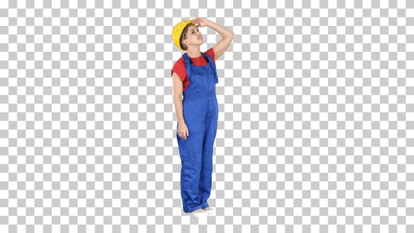 Engineer construction worker woman looking up at a building