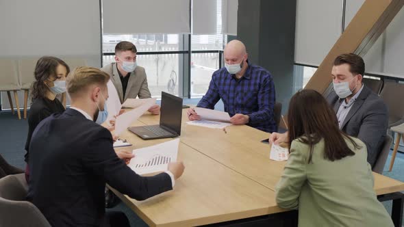 Business People Having a Meeting Working in the Office Wearing Medical Mask