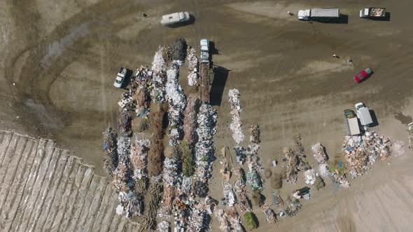 Aerial Footage of Trucks Dumping the Trash Along Air Pollutive Landfill