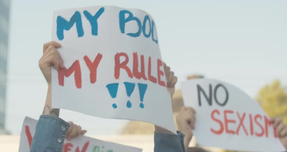 Close-up of My Body My Rules Poster in Female Caucasian Hands. Unrecognizable Young Feminist Holding