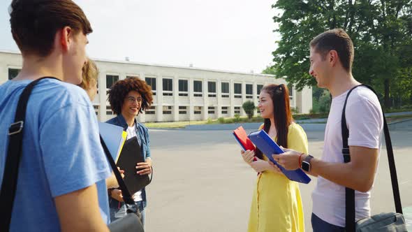 Cheerful Students Meeting Near College Building