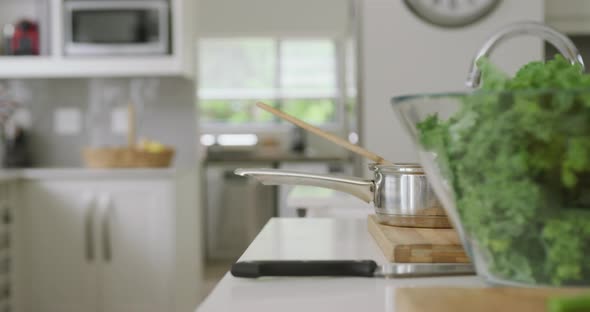 Video of bowl with salad and utensils lying on countertop in kitchen