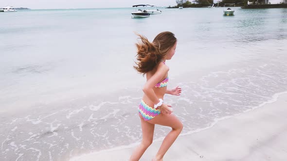 Girl running at beach, Mauritius