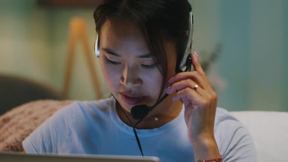 Asian Freelancer Making Video Call in Evening