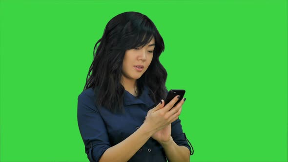 Businesswoman Using of Mobile Phone on a Green Screen, Chroma Key