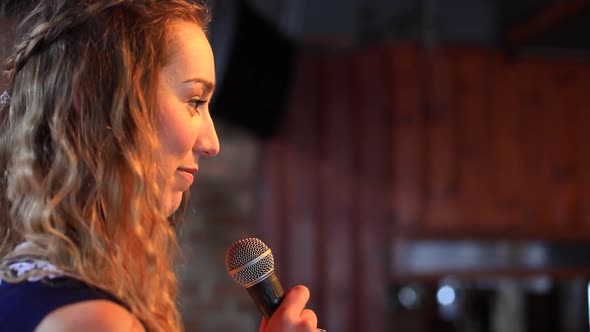 Woman on Stage Listening to Audience