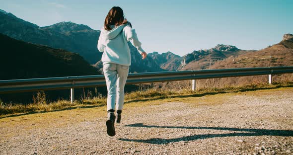 Happy Hipster Female Traveler Run to Road Side Mountain Edge on Summer Journey