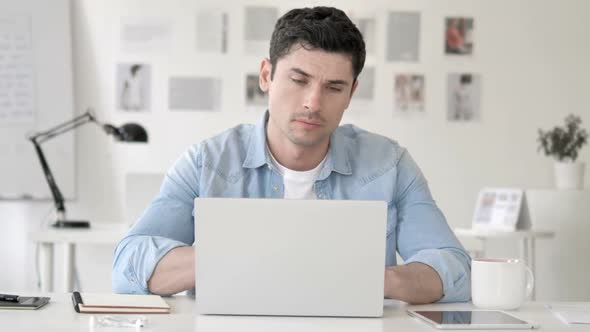 Casual Young Man with Neck Pain at Work