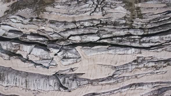 Glacier Covered with Stone Rocks Deep Cracks and Small Waterfalls