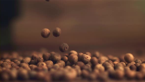 Super Slow Motion Black Pepper Peas Fall Into a Heap