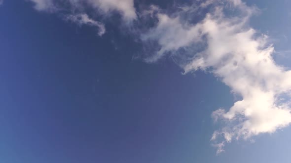 Time Lapse of Fluffy Clouds Moving in Blue Sky on Sunset