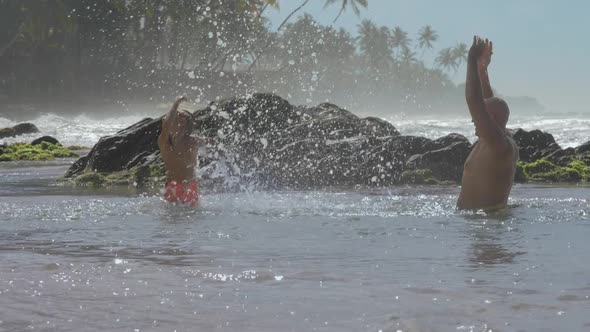 Dad and Son Play in Warm Sea at Tropical Resort Slow Motion