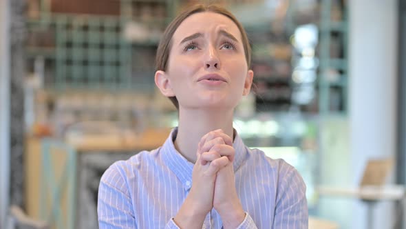 Portrait of Hopeful Young Businesswoman Praying