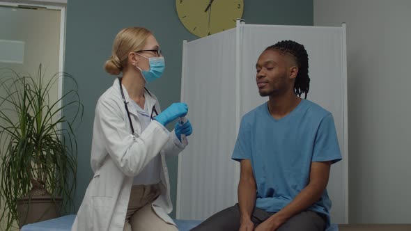 Healthcare Specialist Taking Nasal Mucus Test Sample From Man Indoors