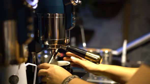 Professional Barista Making Specialty Coffee - Preparing to Extract Espresso Shot.