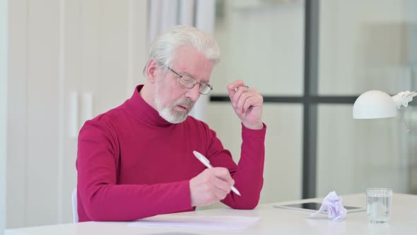 Old Man Having Failure While Writing on Paper