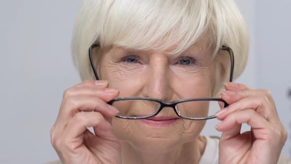 Smiling Senior Woman Fitting Eyeglasses