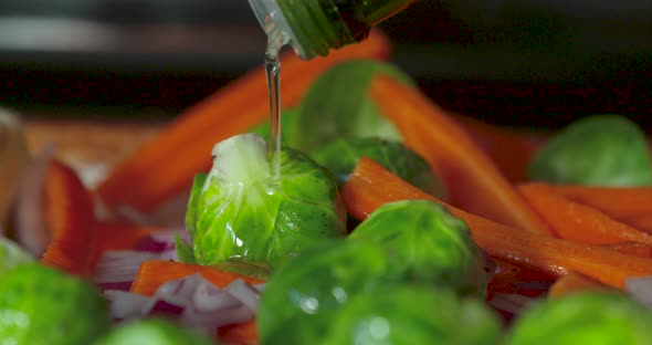 Pouring oil over fresh vegetables before cooking.