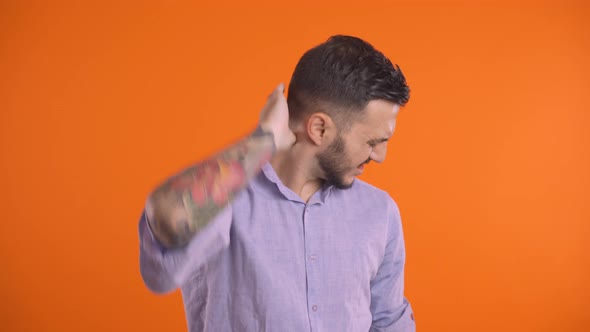 Young Man Man Suffering From Neck Pain, Touching His Neck and Head, Giving It a Massage