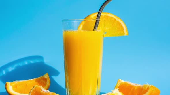 Zoom in Out Glass of Fresh Squeezing Orange Juice with Eco Metal Drinking Straw Sliced Fruits on