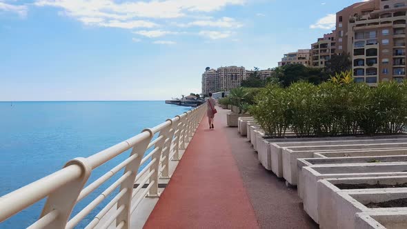 Young Woman Walking Along Coastline, Admiring Seascape, Well Organized District