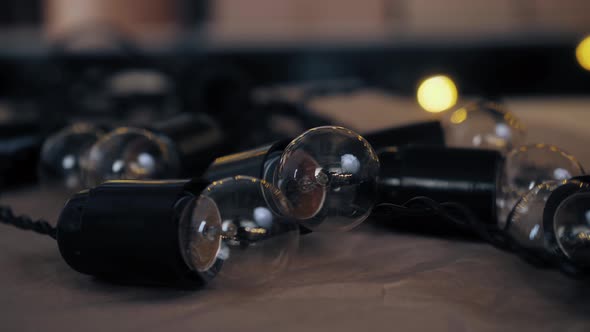 Close Up of Christmas Garland with Transparent Light Bulbs in Stock Warehouse