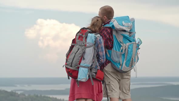 Couple of Tourists Enjoying View from Mountain