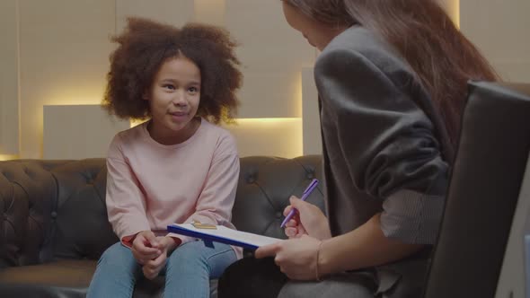 Cute Preadolescent Black Kid Having Emotional Problem Working with Counsellor