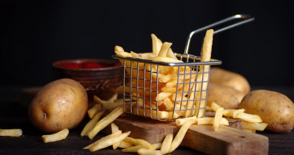 French Fries in Basket on Cutting Board with Tomato Sauce Slowly Rotates. 