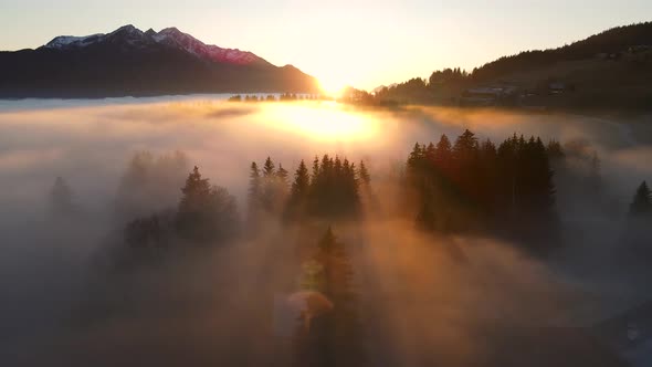 Dense clouds over mountain valley at sunset