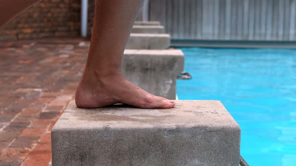 Female swimmer preparing to dive in pool