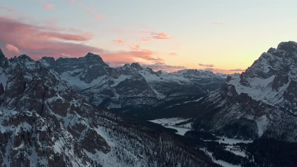 Establishing drone shot of Misurina Valley at sunset in the winter