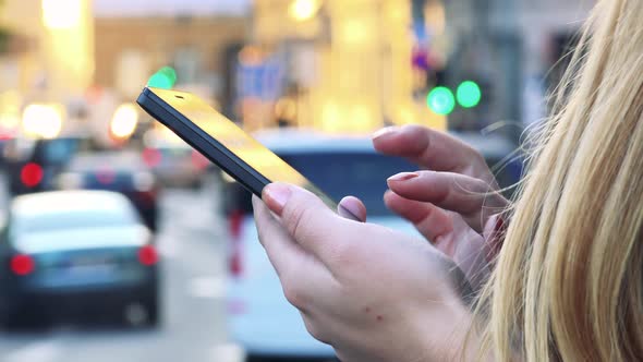 Young Beautiful Woman Works on Smartphone in City - Street with Cars - Closeup