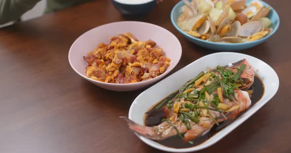 Home cooking with steamed fish, fry egg of pork and fry of clam