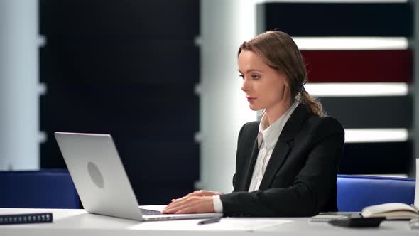 Fashionable Business Woman in Suit Chatting Surfing Internet on Laptop