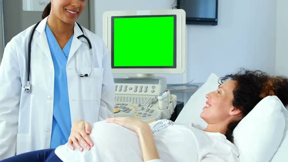 Doctor interacting with pregnant woman