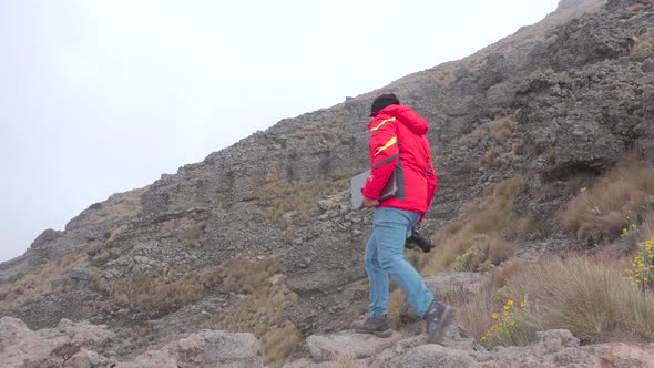 Digital nomad man traveling through the mountains