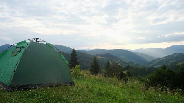 Tourists Set Up a Green Tent in the Alps