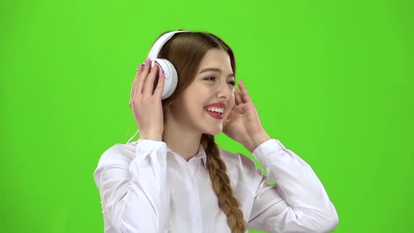 Girl Listens To Music Through Headphones, Green Screen