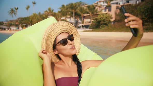 Young Happy Attractive Woman Making Selfie Photo on Mobile Phone at Tropical Island Beach. Tourist