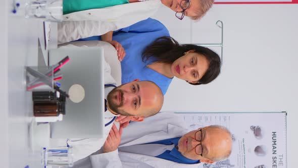 Vertical Video Group of Doctors Having Health Brainstorming Conference