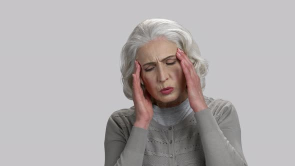 Old Lady Touching Her Temples Because of Headache