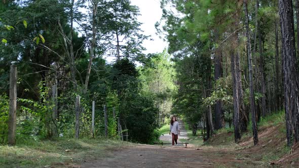 A woman walking into the woods